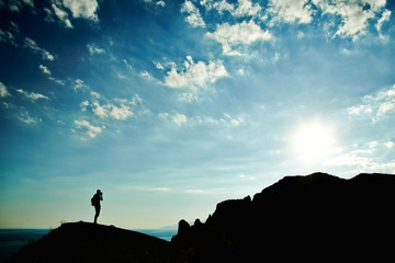 Man silhouette at sunset in mountains