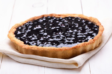 Blueberry pie on white wooden table