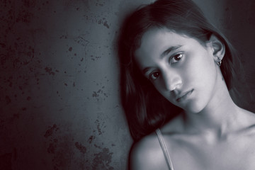 Black and white portrait of a sad teenage girl