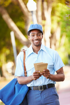 Mailman Walking Along Street Delivering Letters