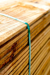 Stacked unpainted wood picket fence lumber