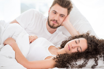 Fototapeta na wymiar Husband admiring his sleeping wife