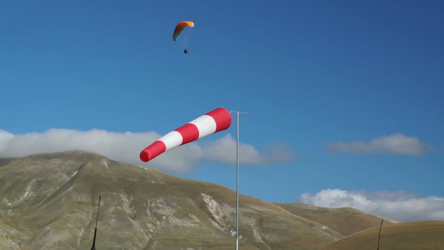 In mountains of Italy wind sleeve and paragliding