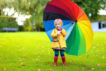 Portrait of small preschooler girl with colorful umbrella