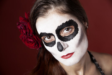 Woman with makeup of la Santa Muerte with red roses