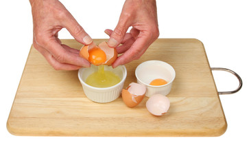 Hands separating eggs