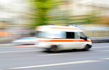 Ambulance in motion driving down the road