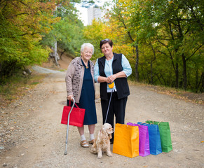 Two women standing with shopping bags