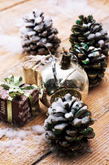 legacy glass Christmas toy on the background of pine cones