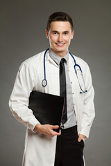 Smiling male nurse posing with laptop