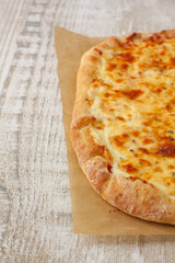 homemade fresh pizza on a wooden background