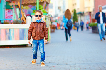 stylish happy boy walking the crowded street