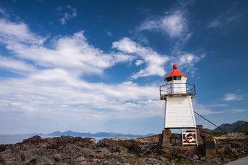 beautiful lighthouse on the edge of rocky sea coast