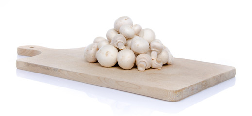 Heap of fresh button mushrooms on a wooden board