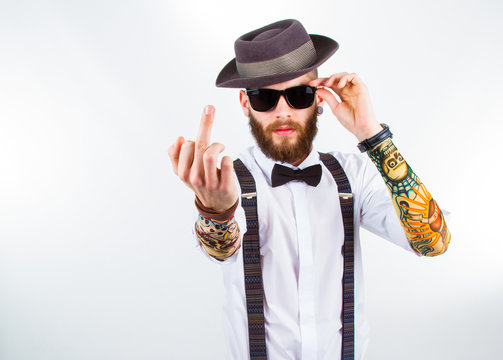 portrait of a stylish hipster showing his f-finger