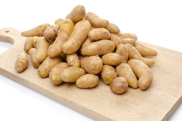 New rattes potatoes on a wooden board