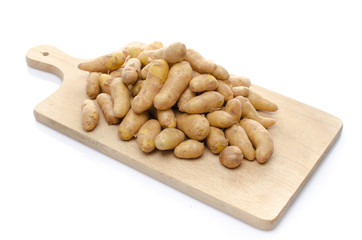 New rattes potatoes on a wooden board