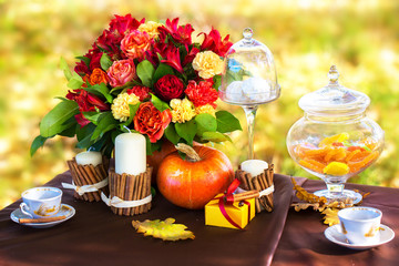 Decorated table for a romantic dinner in autumn Park.