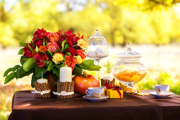 Decorated table for a romantic dinner in autumn Park.