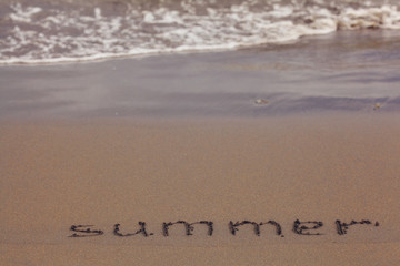 beach sand summer inscription on the sand