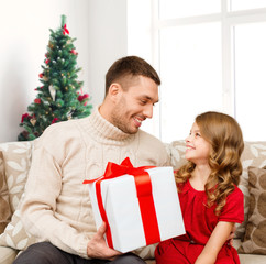 smiling father and daughter with gift box