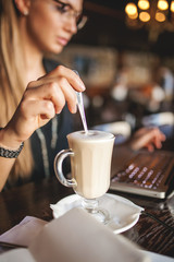 Business woman in cafe with coffee and laptop