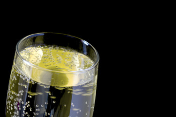 Close up image of top of full champagne glass