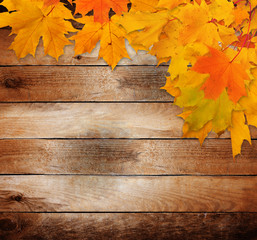 Naklejka na ściany i meble Bright autumn leaves on the old grunge wooden background