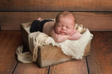 Sleeping Baby Boy in Wooden Crate