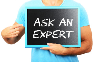 Man holding blackboard in hands and pointing the word ASK AN EXP