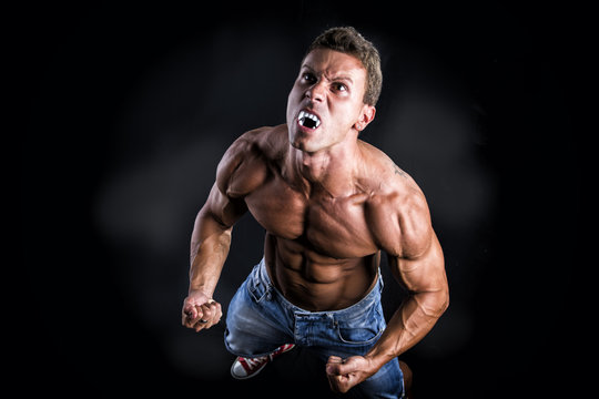 Shirtless Muscle Man with Pointed Teeth Howling