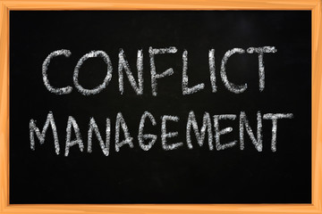 Obraz premium Conflict Management Chalk Writing on Blackboard