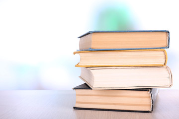 Books on wooden table on natural background