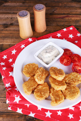 Chicken nuggets with sauce on table close-up