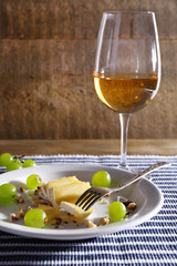beautiful still life with wine, cheese and ripe grape