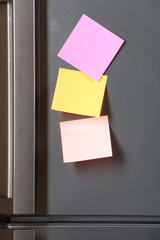 Note on piece of paper on refrigerator closeup