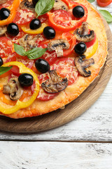 Delicious pizza served on wooden table