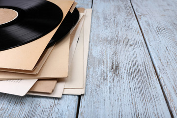 Fototapeta na wymiar Vinyl records records and paper covers on wooden background