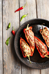 Delicious stuffed peppers in frying pan on table close-up