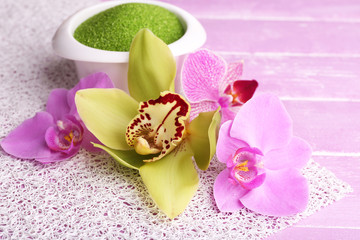Tropical orchid flowers on color wooden background