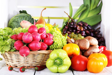 Vegetables in basket on white wooden box background