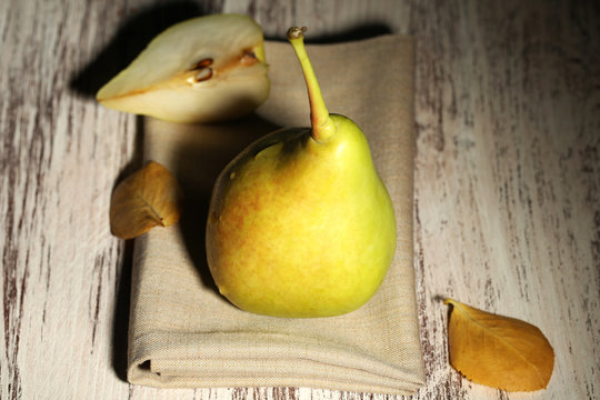 Ripe tasty pear on wooden table