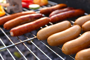 Sausages on barbecue grill, close-up