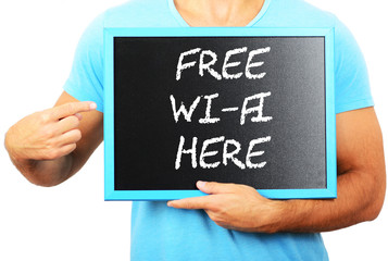 Man holding blackboard in hands and pointing the word FREE WI- F