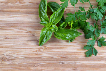 Fresh herbs on natural bamboo board