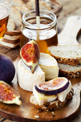Breakfast setting with bread, cheese, figs and honey