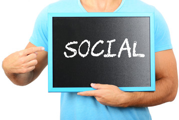 Man holding blackboard in hands and pointing the word SOCIAL