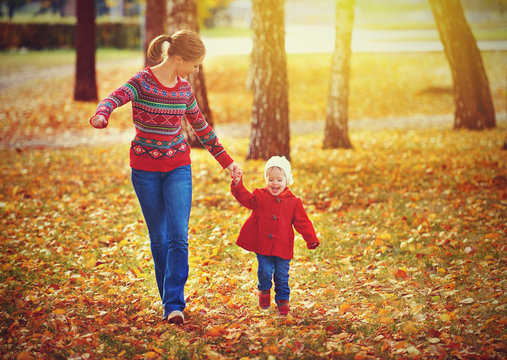 happy family mother and child little daughter on autumn walk