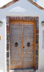 Wooden door from whitewashed house. Thira (Santorini), Greece.
