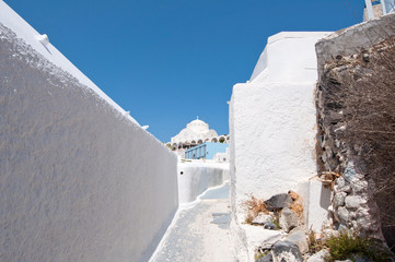 Narrow whitewashed street in Fira town. Santorini, Greece. © lornet